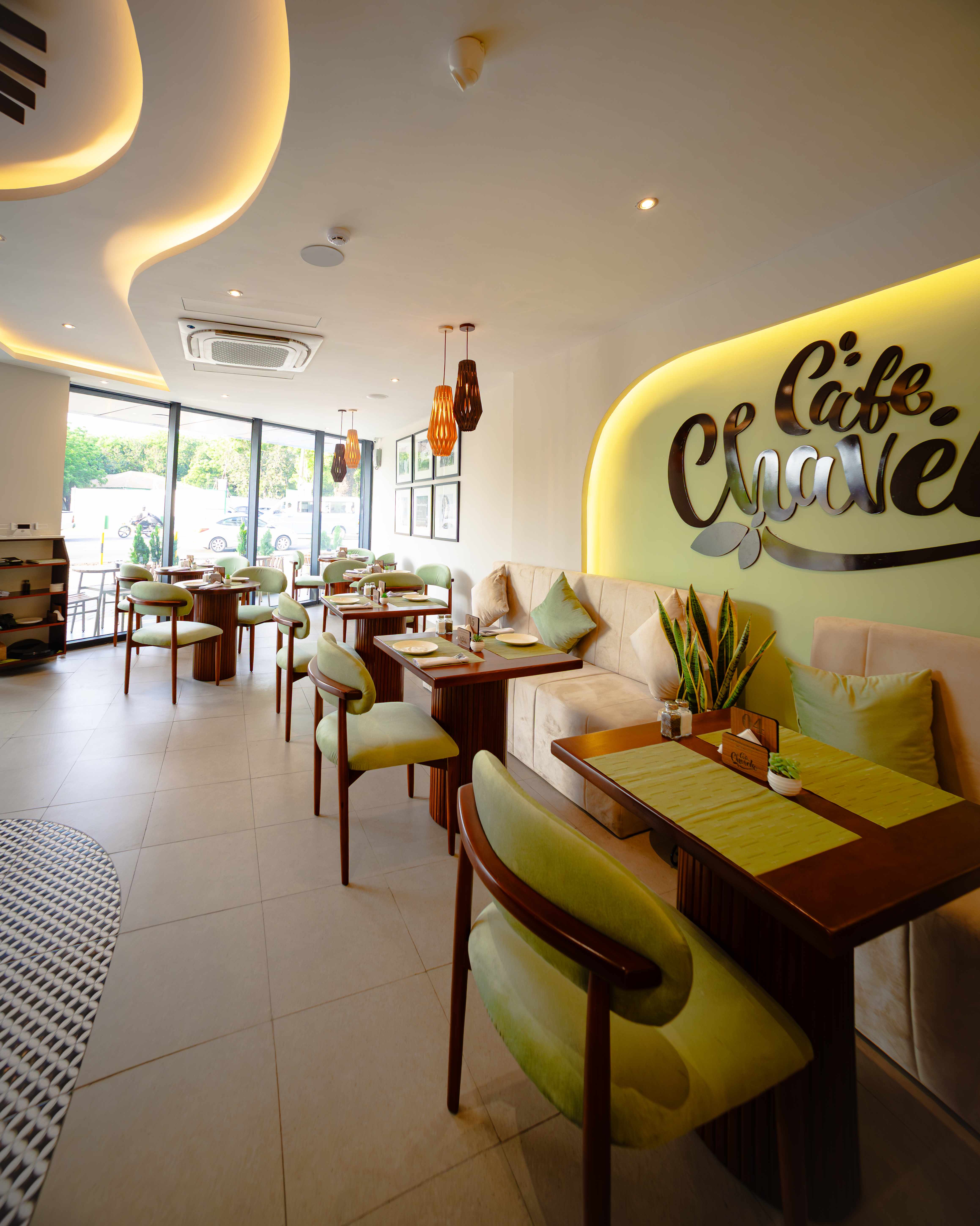 Café Chavela interior with sage green chairs and cozy seating