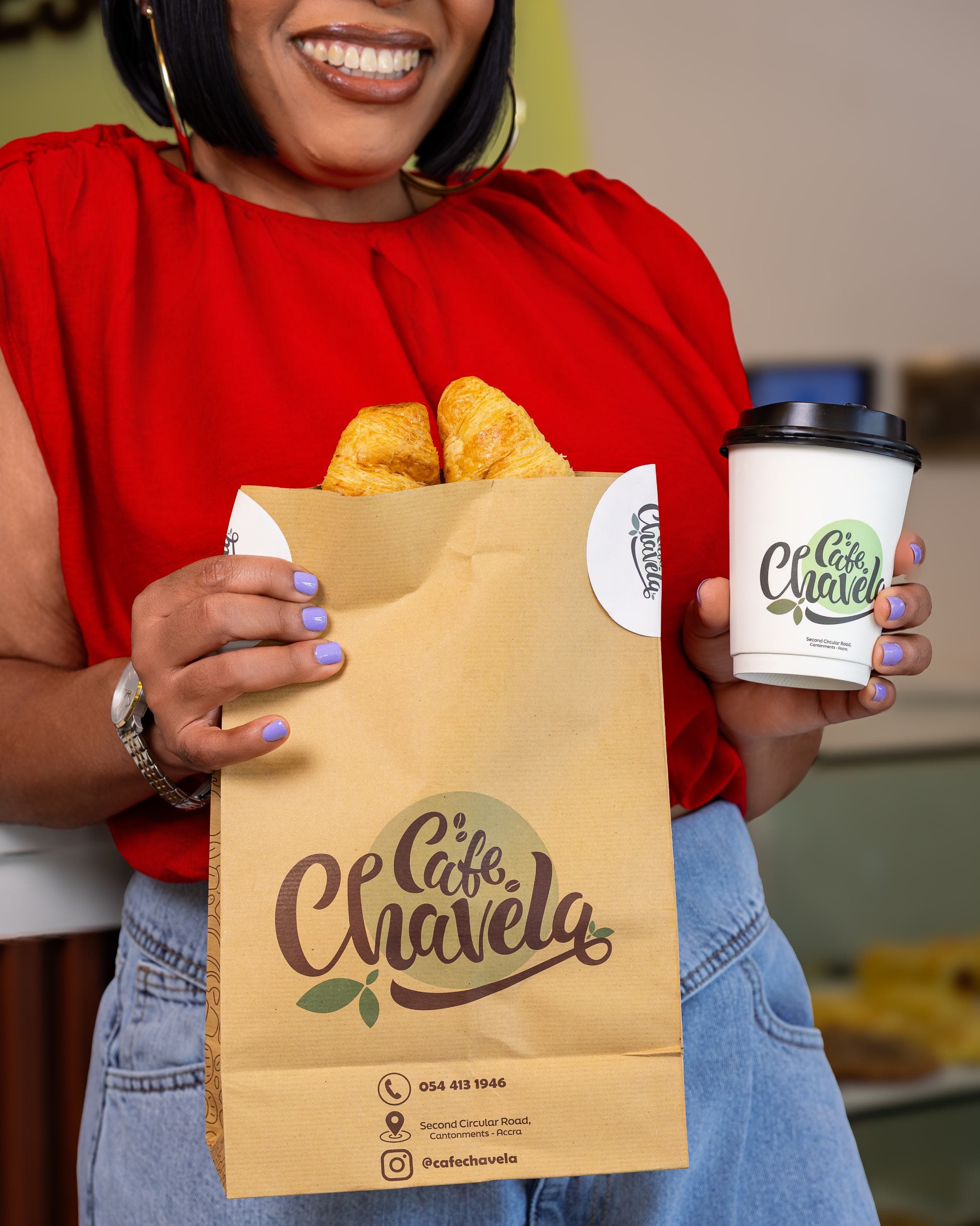 Customer with Café Chavela takeaway bag and coffee