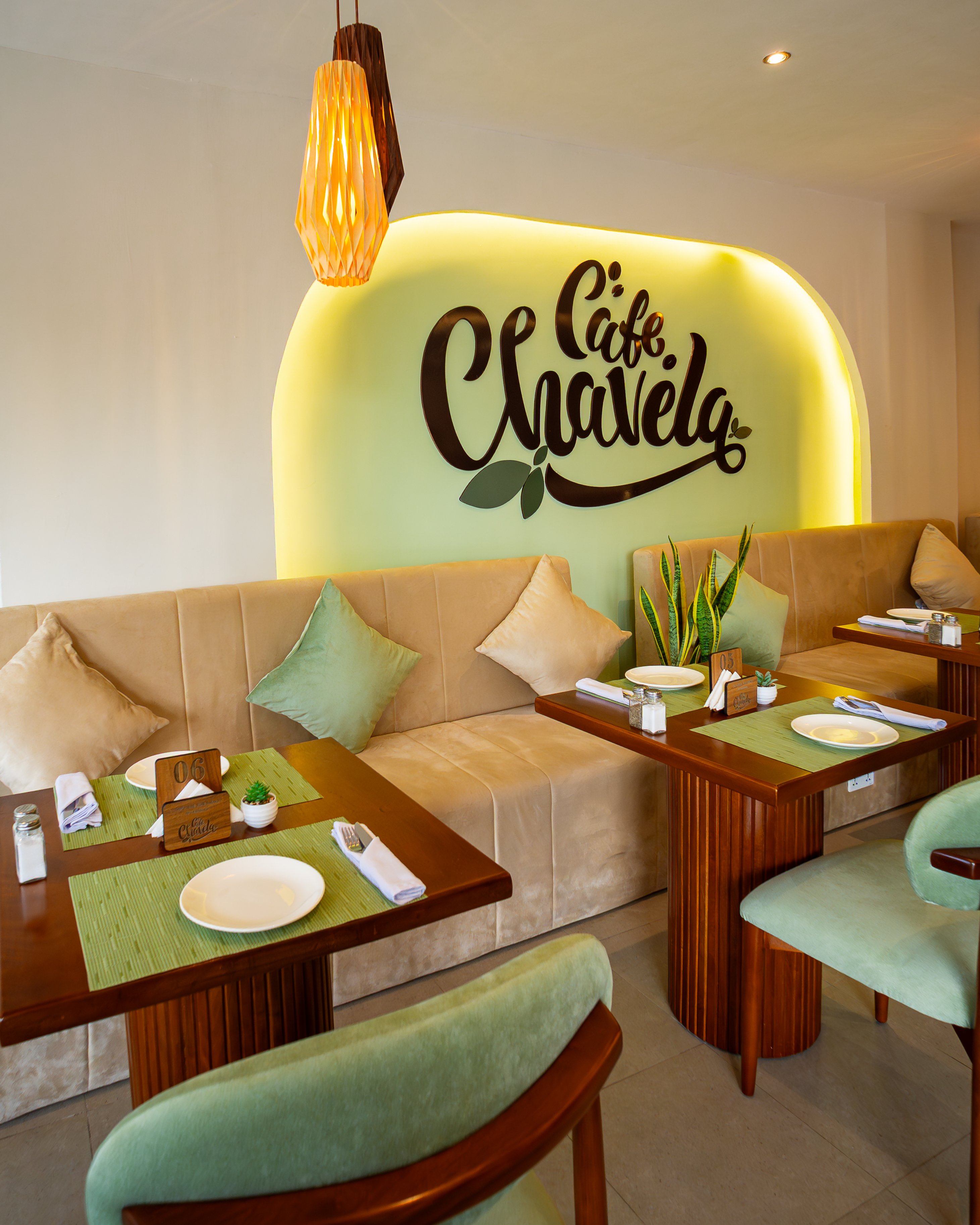 Café Chavela seating area with illuminated logo