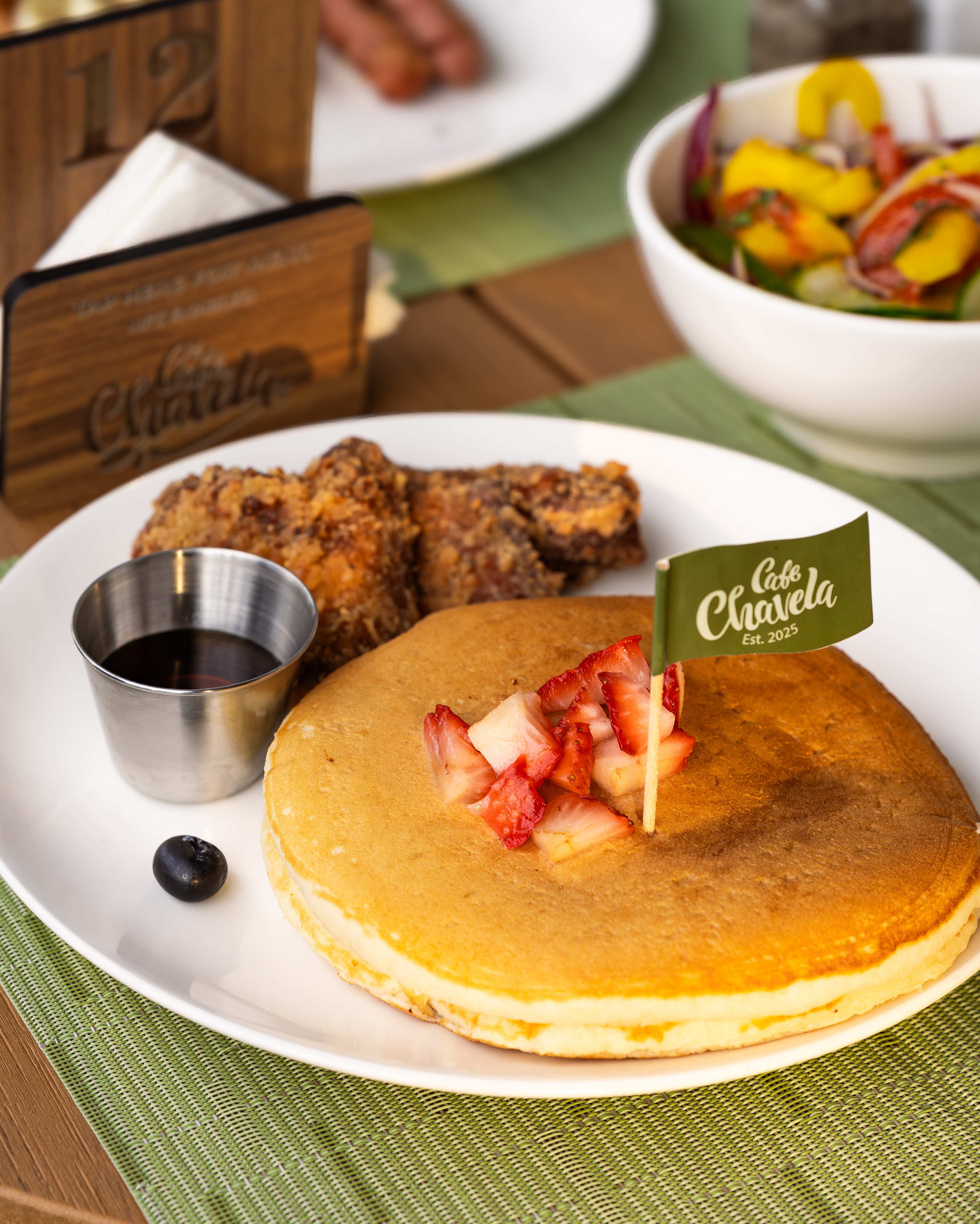 Fluffy pancakes with strawberries and fried chicken